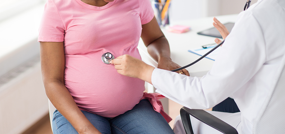 Pregnant woman being examined by a physician
